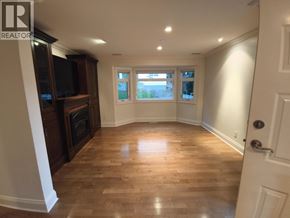 Belcarra apartment for rent - A room with wooden floors and a door on the right side.