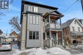 Ottawa multi-family for rent - A two-story house with a grey and brown exterior is for sale.