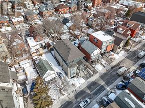 Ottawa multi-family for rent - A winter scene of a residential area with houses and cars.