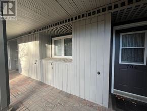 Collingwood condo for rent - A white building with a black door and a window.