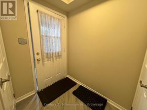Collingwood condo for rent - A hallway with a door and a mat on the floor.