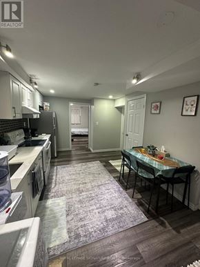 Waterloo apartment for rent - A kitchen with a table and chairs in the middle of the room.