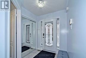 Vaughan (Vellore Village) apartment for rent - A hallway with a glass door and a chandelier.