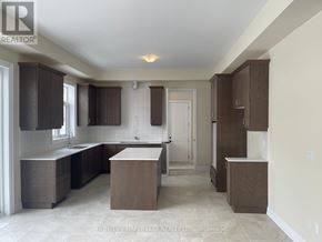 Oro-Medonte apartment for rent - A kitchen with brown cabinets and a white countertop.