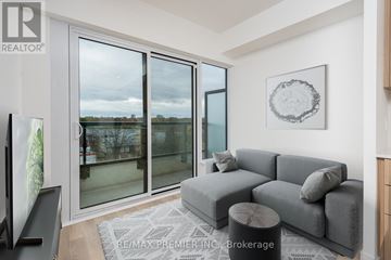 Toronto (Bendale) condo for rent - A living room with a grey couch and a framed picture on the wall.