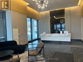 Toronto (Bendale) condo for rent - A reception area with a white reception desk and a black leather chair.