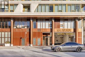 Toronto (Annex) condo for rent - A silver car is parked in front of a building with the sign 151 Avenue.