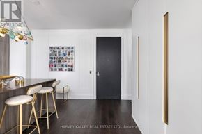 Toronto (Annex) condo for rent - A modern kitchen with a bar area and stools.
