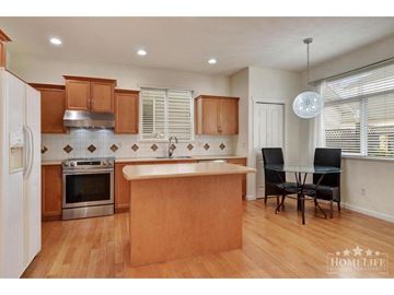 Langley apartment for rent - A kitchen with wooden cabinets and a white refrigerator.
