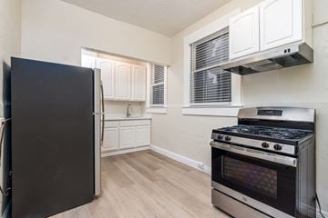 San Francisco apartment for rent - A kitchen with a black fridge and stove.