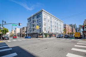 San Francisco apartment for rent - A street view with cars, a truck, and a yellow box on the right.