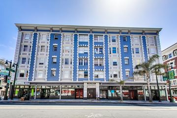 San Francisco apartment for rent - A blue and white building with shops on the ground floor.