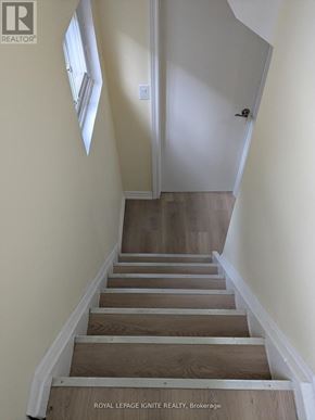 Toronto (Tam O'shanter-Sullivan) apartment for rent - A staircase with wooden steps and white walls.