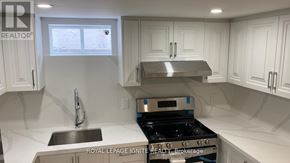 Toronto (Tam O'shanter-Sullivan) apartment for rent - A kitchen with white cabinets and a stainless steel stove top.