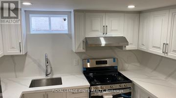 Toronto (Tam O'shanter-Sullivan) apartment for rent - A kitchen with white cabinets and a stainless steel stove top.