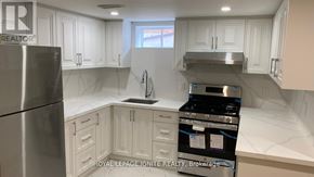 Toronto (Tam O'shanter-Sullivan) apartment for rent - A kitchen with white cabinets and stainless steel appliances.