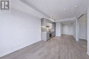 Vaughan (Vaughan Corporate Centre) condo for rent - A spacious room with a kitchenette and wooden flooring.