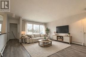 Fort Erie (Crescent Park) apartment for rent - A spacious room with a large window and a door on the right side.