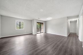 Atlanta apartment for rent - an empty living room with wood floors and a door to a balcony