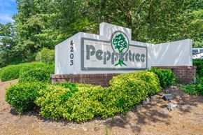 Atlanta apartment for rent - a sign with bushes and trees