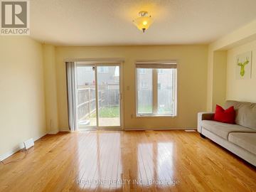 Mississauga (Churchill Meadows) townhouse for rent - A living room with a couch and sliding glass doors.