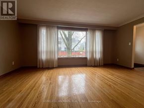 Markham (Unionville) apartment for rent - A room with wooden flooring and a large window with curtains.