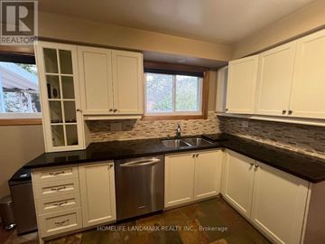 Markham (Unionville) apartment for rent - A kitchen with white cabinets and a black countertop.
