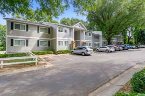 Atlanta apartment for rent - an apartment building with cars parked in a parking lot