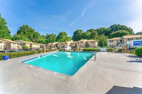 Decatur apartment for rent - a swimming pool in a parking lot with apartments in the background