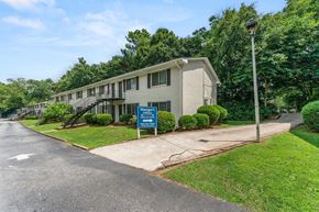 Forest Park apartment for rent - a white building with a blue sign in front of it