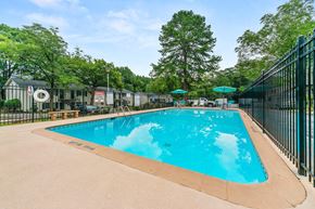 Forest Park apartment for rent - a swimming pool with a fence around it and trees
