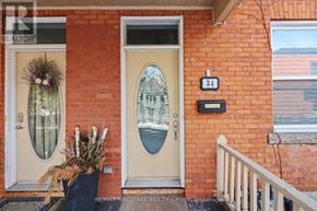 Ottawa apartment for rent - A red brick house with a white door and a number 34 on the wall.
