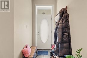 Ottawa apartment for rent - A woman in a black coat is standing in front of a white door.