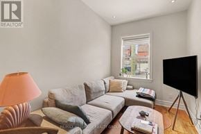 Ottawa apartment for rent - A living room with a grey couch, a coffee table, and a flat screen TV.
