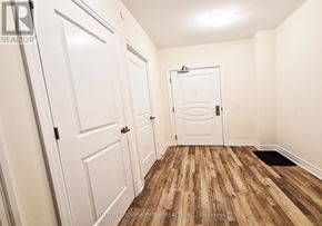 Vaughan (Concord) condo for rent - A hallway with white doors and a wooden floor.