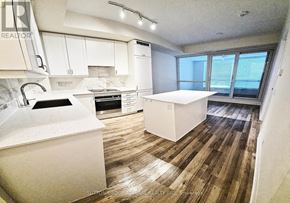 Vaughan (Concord) condo for rent - A kitchen with white appliances and wooden floors.