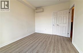 Hamilton apartment for rent - A room with a white door and a wooden floor.