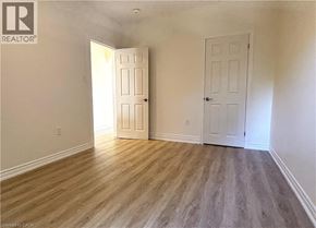 Hamilton apartment for rent - A room with two doors and wooden flooring.