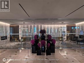 Toronto (Waterfront Communities) condo for rent - A modern office space with a glass wall and a reception desk.