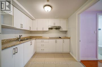 Toronto (Agincourt South-Malvern West) apartment for rent - A kitchen with white cabinets and a granite countertop.
