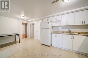 Toronto (Agincourt South-Malvern West) apartment for rent - A kitchen with white cabinets and a white refrigerator.