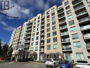 Richmond Hill (Langstaff) condo for rent - A Bay Street Group Inc. building with cars parked in front.