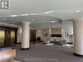 Richmond Hill (Langstaff) condo for rent - A spacious lobby with a fireplace and seating area.