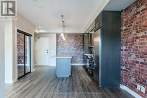 Burlington (Lasalle) condo for rent - A kitchen with a brick wall and wooden floors.