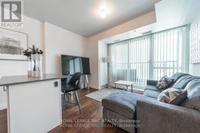 Niagara Falls (Oldfield) condo for rent - A living room with a grey couch and a television.