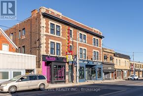 Hamilton (Gibson) apartment for rent - A street view with a building that has a pink sign on it.