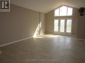 Niagara Falls (Schisler) apartment for rent - A sunny room with tile flooring and a large window.
