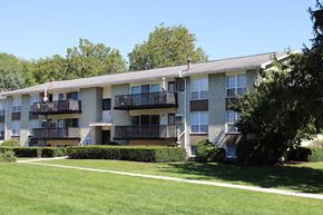 Lancaster apartment for rent - an apartment building with balconies and a grass yard