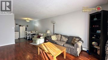 North Vancouver apartment for rent - A living room with a grey couch and a wooden coffee table.