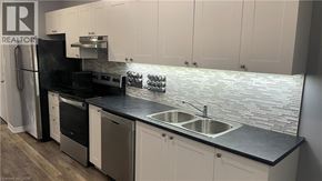 Hamilton apartment for rent - A kitchen with a black counter top and white cabinets.